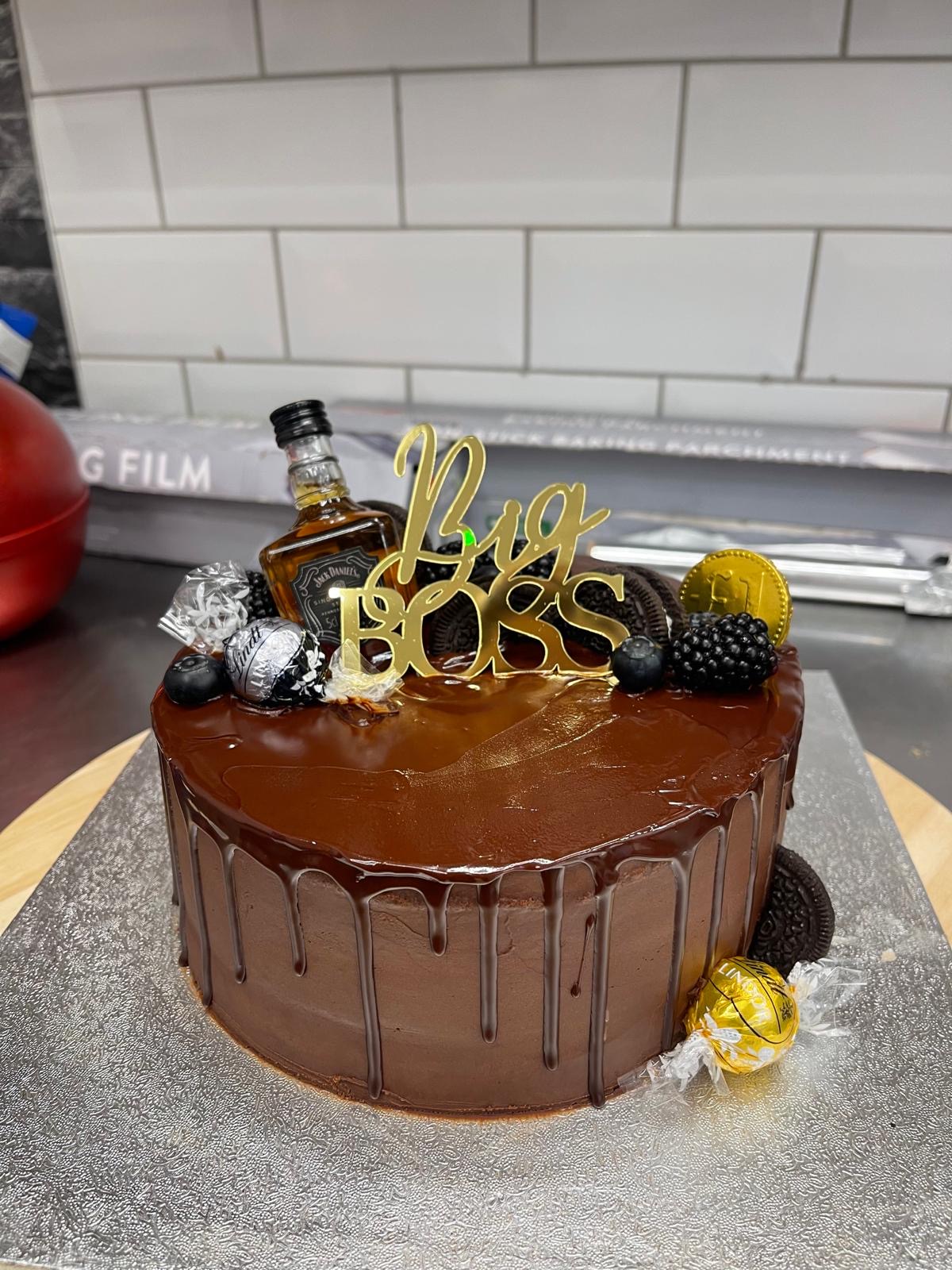 Chocolate drip celebration cake with gold lettering
