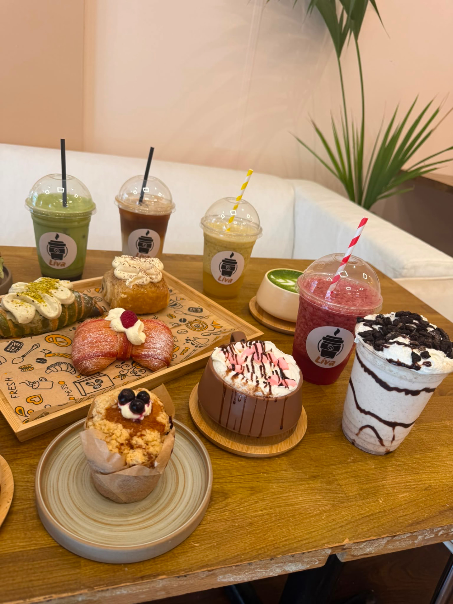 A table spread of Liva drinks and pastries